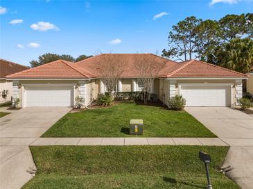 Charming single Gathering home boasting well-manicured lawn and barrel tile roof at 2625 Albion Ave, Orlando, FL 32833