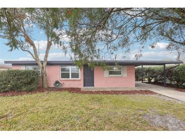 Charming single-story brick home featuring a covered carport and a well-maintained front yard at 2943 Truman Blvd, Sanford, FL 32771