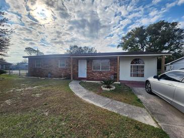 Charming single-story brick home featuring a well-maintained lawn and walkway at 3430 Kathy Ct, Lakeland, FL 33810