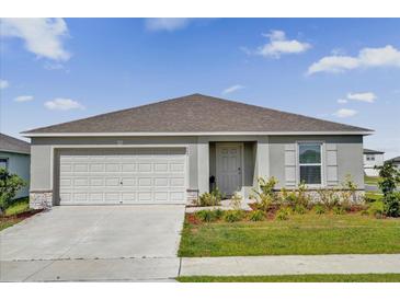 Charming single-story home with a two-car garage, well-manicured lawn and stone accents at 545 Jerry Ln, Haines City, FL 33844