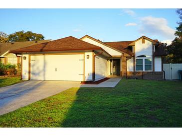 Charming single-story home with a two-car garage, manicured lawn, and inviting curb appeal at 6501 Abercrombie Ct, Orlando, FL 32835