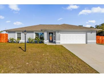 Charming single-story home featuring a well-maintained lawn and attached two-car garage at 13258 Sw 29Th Cir, Ocala, FL 34473