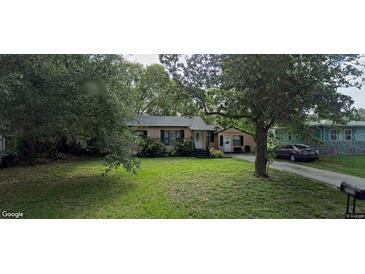 Charming one-story home with a well-manicured front yard, mature trees, and inviting curb appeal at 2429 S Elm Ave, Sanford, FL 32771