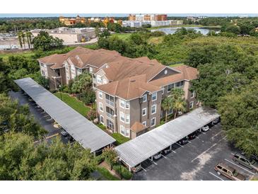 A charming condo building with lush landscaping and covered parking spots at 7123 Yacht Basin Ave # 328, Orlando, FL 32835