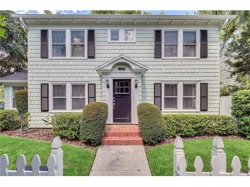 Charming two-story home featuring shake siding, black shutters, and neatly manicured landscaping at 728 N Summerlin Ave, Orlando, FL 32803