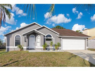 Charming single-story home with well-manicured lawn and an attached two-car garage at 8076 Aspencrest Ct, Orlando, FL 32835