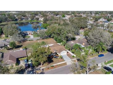 Aerial view of the home, showcasing the lawn, driveway and surrounding neighborhood at 8851 Hillsdale Dr, Orlando, FL 32818