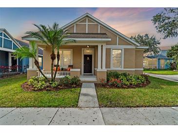 Charming single-Gathering home featuring manicured landscaping and a cozy front porch with palm tree at 14149 Paradise Tree Dr, Orlando, FL 32828