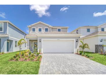 Charming two-story home featuring a spacious two-car garage and a well-manicured front yard at 3811 Lana Ave, Davenport, FL 33897