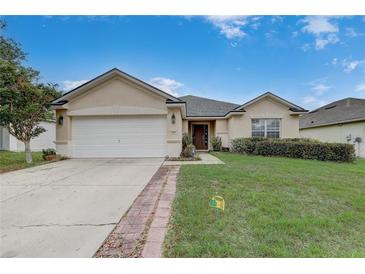 Charming single-story home featuring a two-car garage, well-maintained lawn and garden, and a welcoming entryway at 3995 Sw 57Th Ct, Ocala, FL 34474