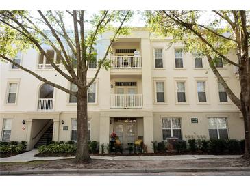 Charming condo building with multiple balconies and manicured landscaping at 1020 Siena Park W Blvd # 103, Celebration, FL 34747