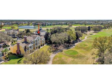 Scenic aerial view of a community near a golf course and lake at 1338 Seven Eagles Ct # 302, Reunion, FL 34747