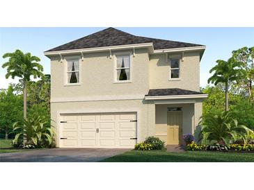 Two-story home with a two-car garage, neutral stucco exterior, complemented by lush landscaping and a paver driveway at 1839 Waggoner St, Kissimmee, FL 34744