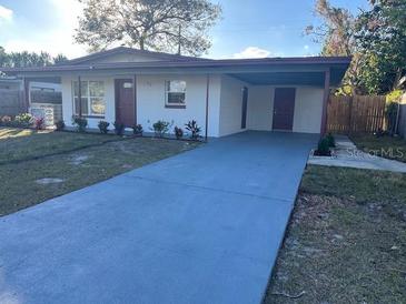 Charming single-story home with a well-maintained lawn and inviting carport at 1926 Kingsland Ave, Orlando, FL 32808