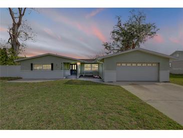 Charming single-story home with a well-manicured lawn and inviting curb appeal at sunset at 2130 Pope Ave, South Daytona, FL 32119