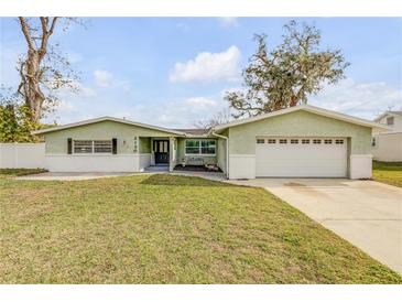 Charming single-story home with a well-manicured lawn and attached two-car garage at 2130 Pope Ave, South Daytona, FL 32119