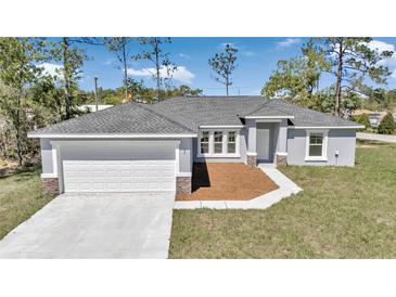 Charming single-story home featuring a gray exterior, gray roof, and a two-car garage at 280 Marion Oaks Golf Way, Ocala, FL 34473