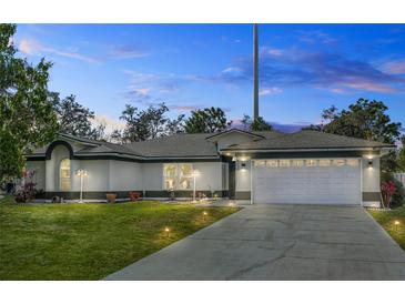 Charming single-story home featuring a well-manicured lawn, two-car garage, and inviting curb appeal at 4100 Cannon Ct, Kissimmee, FL 34746