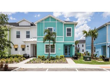 Charming two-story home with modern design and colorful, tropical facade at 8179 Coconut Pl, Kissimmee, FL 34747