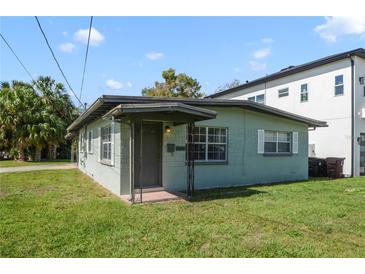 Charming single-story home with a covered porch and lush green lawn at 1600 Hart Ln, Orlando, FL 32804