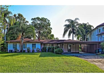 Charming single story home with a well-maintained lawn and mature trees at 3045 Cecelia Dr, Apopka, FL 32703