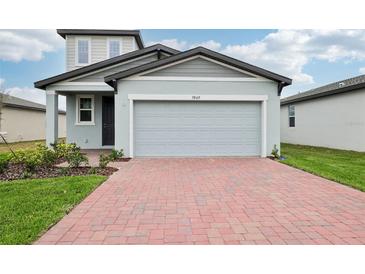 Charming two-story home with an attached two-car garage and manicured landscaping at 3845 Giorgio Dr, Winter Haven, FL 33884