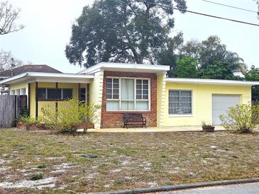 Charming single-story home with yellow exterior and brick accents at 420 W Crystal Dr, Sanford, FL 32773