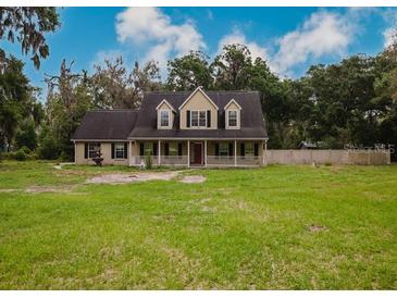 Charming two-story home with a welcoming front porch and a spacious front yard, perfect for outdoor activities at 6801 County Rd 665, Bushnell, FL 33513