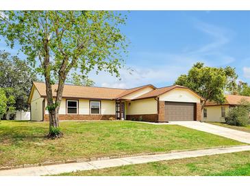 Charming single Gathering home featuring a well maintained lawn, attached garage and lovely curb appeal at 9236 Baton Rouge Dr, Orlando, FL 32818