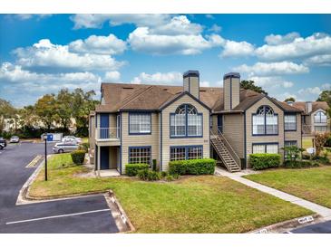 Inviting two-story condo with neutral exterior, blue accents, and well-maintained landscaping at 939 Framlingham Ct # 101, Lake Mary, FL 32746