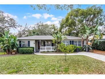 Charming single-story home with lush landscaping, inviting curb appeal, and a classic front porch at 1320 Golfview St, Orlando, FL 32804