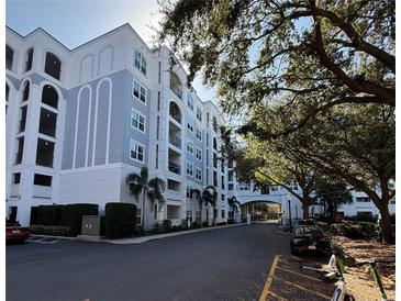 Beautiful condominium complex with lush landscaping and a covered entryway at 202 E South St # 5037, Orlando, FL 32801