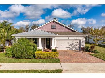 Charming single-story home with brick driveway, manicured lawn, and attached two-car garage at 2157 Bay Line Rd, Oakland, FL 34787