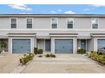 Charming townhome featuring a one-car garage, welcoming entryway, and well-maintained landscaping at 3086 Fieldwood Cir, St Cloud, FL 34772