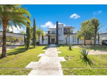 Modern two-story home featuring a manicured lawn and distinctive walkway at 34500 Tree Frog Ln, Eustis, FL 32736