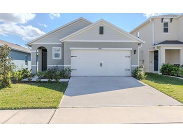 Charming home featuring a two-car garage, manicured lawn, and lovely curb appeal at 3762 Sungrove Cir, Sanford, FL 32771