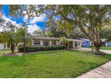 Charming single-story home with a well-manicured lawn, mature trees, and neutral exterior paint at 5214 E Kaley St, Orlando, FL 32812