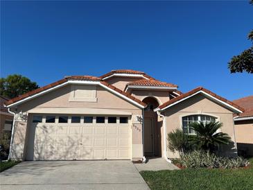 Charming home showcasing a well-maintained lawn and a red tile roof at 5337 Watervista Dr, Orlando, FL 32821