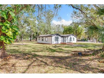 Charming single story home with black trim and a large manicured front yard at 850 Rosalia Dr, Sanford, FL 32771