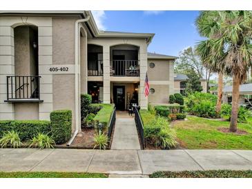 Inviting condo with walkway to front door, pretty landscaping and stacked balconies at 1055 Kensington Park Dr # 402, Altamonte Springs, FL 32714