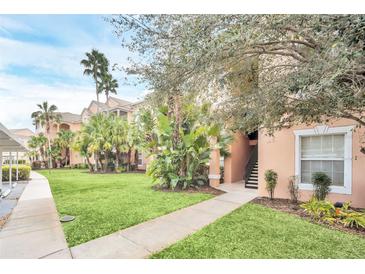 Inviting condo exterior with lush landscaping, palm trees and a well-maintained lawn at 13500 Turtle Marsh Loop # 839, Orlando, FL 32837