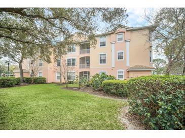 Charming condo building with lush landscaping, manicured lawn, and private screened balconies at 13500 Turtle Marsh Loop # 839, Orlando, FL 32837