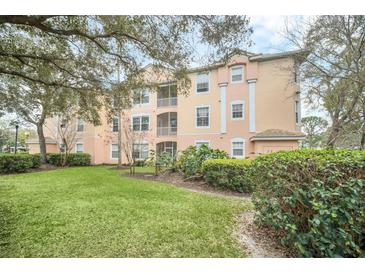 Beautiful condo building with well-maintained landscaping and charming architectural details at 13500 Turtle Marsh Loop # 839, Orlando, FL 32837