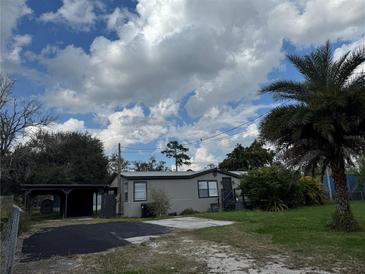 Charming single-story home with well-maintained yard and a convenient carport on a sunny day at 18541 15Th Ave, Orlando, FL 32833