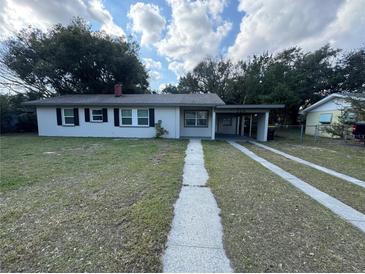 Charming single story home with a front yard and driveway at 220 Palm Ave, Auburndale, FL 33823