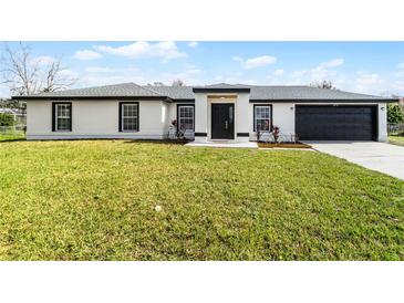 Charming single-story home featuring a fresh exterior, manicured lawn, and a convenient two-car garage at 2751 Carmel Ct, Kissimmee, FL 34746