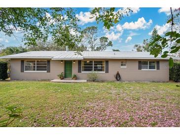 Charming single story home with mature trees and a well-manicured front lawn at 4898 Meadow Dr, St Cloud, FL 34772