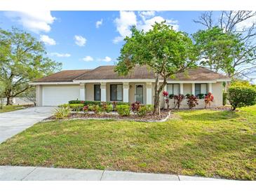 Charming single-story home with well-manicured lawn and colorful landscaping at 517 Seville Ave, Altamonte Springs, FL 32714