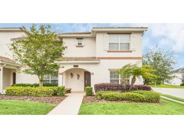 Charming two-story home with a well-manicured front yard and inviting entrance at 9017 Dogleg Dr, Davenport, FL 33896