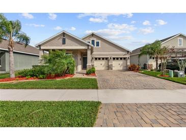 Charming single-Gathering home featuring a two-car garage, manicured lawn and beautiful landscaping at 211 Venetian Palms Blvd, New Smyrna Beach, FL 32168